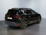 the rear end of a black suv parked in a large room