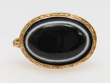 a close up of a ring with a black stone in it