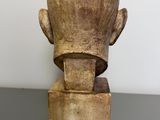 wooden sculpture of a man ' s head on top of a wooden block