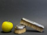 a brush and an apple next to each other on a table
