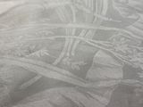 a close up picture of a bed with a white comforter