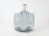 a small blue vase with a white top on a white surface