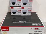 four black and white boxes of video recorders stacked on top of each other
