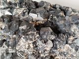 a large pile of black rocks on a white surface