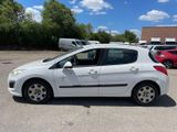 the small white car is parked in the parking lot
