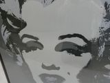 a black and white picture of a woman ' s face in a picture frame