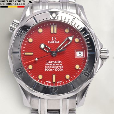 a red watch with a black face on a white surface
