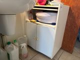 a sink and a cabinet in a small bathroom
