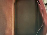 the inside of a purse with a phone inside of it