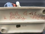 porcelain figurine with writing on it sitting on a table