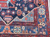 rug on the floor is blue and red with a design on it