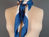 blue and white scarf on mannequin with bird on it