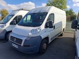 three white vans parked in a parking lot with trees in the background