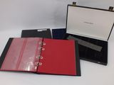three red and black binders are sitting on a white surface