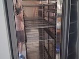 a man standing in front of an open refrigerator in a kitchen