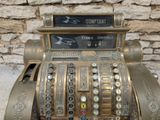 a very old cash register with a lot of buttons on it