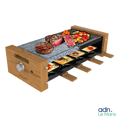 a grill with meat and vegetables on it on a table
