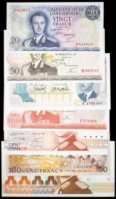 five different bank notes with a picture of a man in a suit and tie