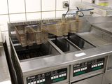 two fryers that are sitting in a kitchen