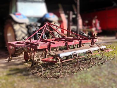 a toy tractor and a plow in a field