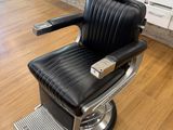 an image of a black barber chair in a room