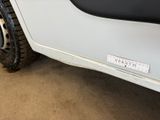 a close up of a white truck with a sticker on it ' s side