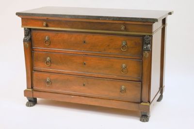 a wooden chest of drawers with a marble top