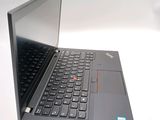 a laptop with a black keyboard on a white surface