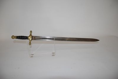 an old sword with a wooden handle on a clear stand