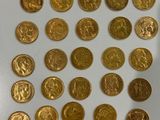 a lot of gold coins on a white surface