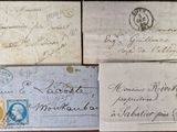 several old envelopes are sitting on top of a wooden table