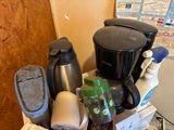 a pile of household items sitting on top of a counter
