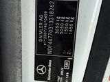 a close up of a parking meter with a red cross on it