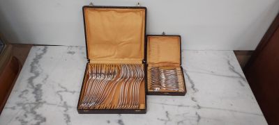 a case with silverware in it sitting on a marble table