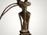 an image of a bronze statue of a woman with long hair