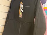 three jackets hanging on a rack in a store