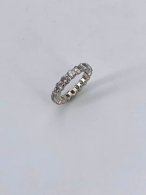 a close up of a diamond ring on a white surface