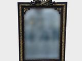 a black and gold frame with a mirror on it