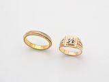 two gold rings with a cross on each side and a cross on the other