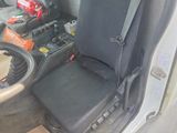 a picture of a seat in a vehicle with tools in the back