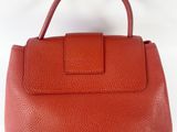 a red leather handbag on a white background