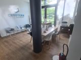 a room with a table, chairs, and a vacuum in it
