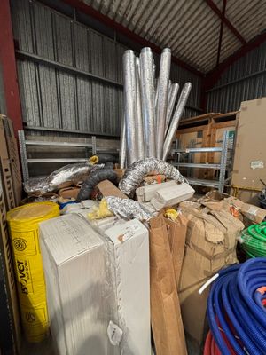 boxes and hoses are stacked on top of each other in a warehouse