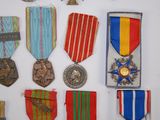 many medals and medals displayed on a white surface