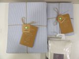 two blue sheets wrapped in twine and tied with twine
