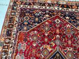 an image of a red and blue oriental rug on a blue floor