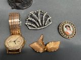 several pieces of jewelry including a watch, broochet, and a bracelet