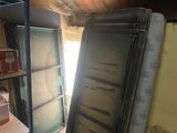 a room that has a bed and a refrigerator in it