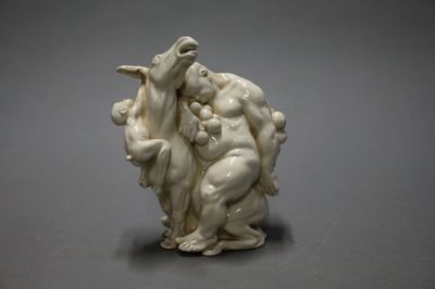 a white sculpture of a man and a woman holding a baby
