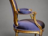 a purple chair with gold trim and a blue upholstered seat